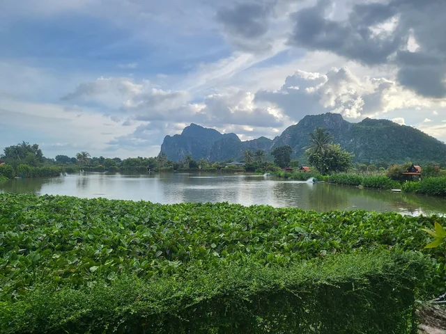 Jurassic Mountain lake with shelters and mountains beyond